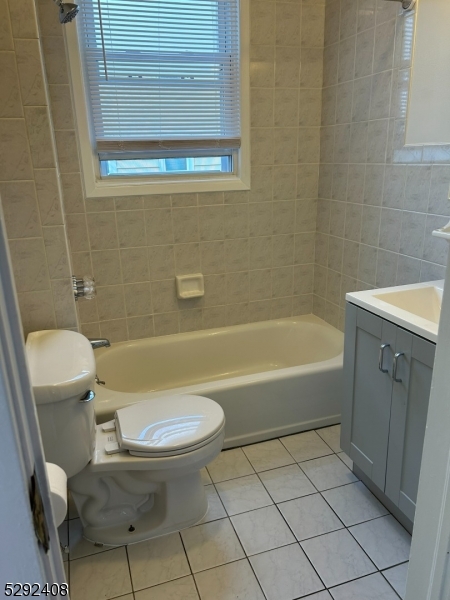 136 Carlton Avenue, Unit 1 East Rutherford, NJ 07073 - Photo 9 of 16 a bathroom with a sink a toilet and bathtub