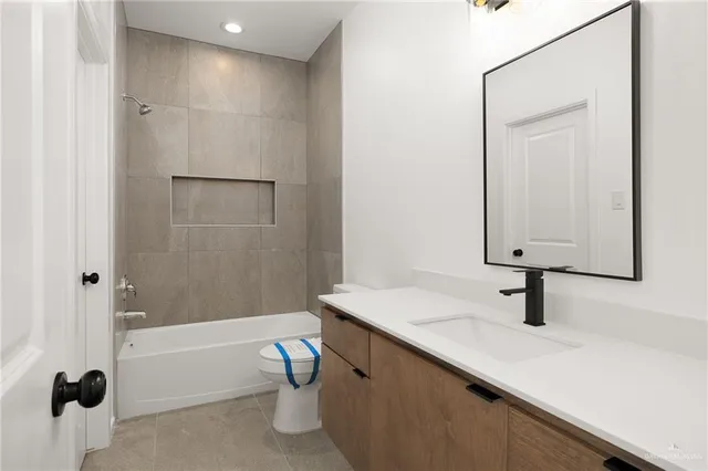 a bathroom with a sink a toilet a mirror and shower
