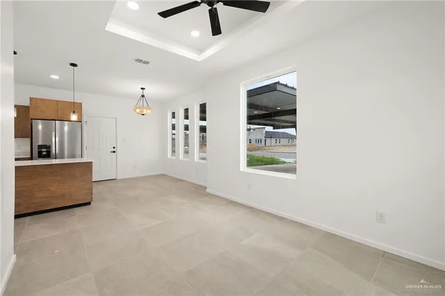 an empty room with windows and cabinet