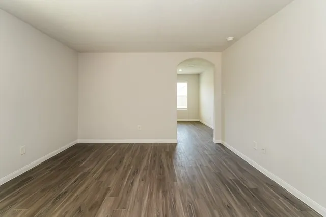 a view of a room with wooden floor and white walls