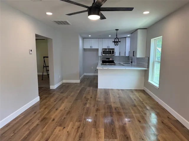 a view of kitchen with sink microwave and stove