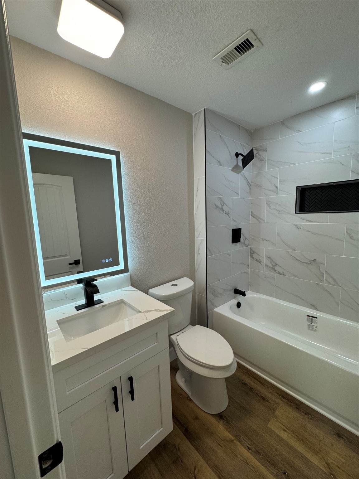 4301 Peck Avenue Santa Fe, TX 77517 - Photo 4 of 8 a bathroom with a sink a toilet and shower