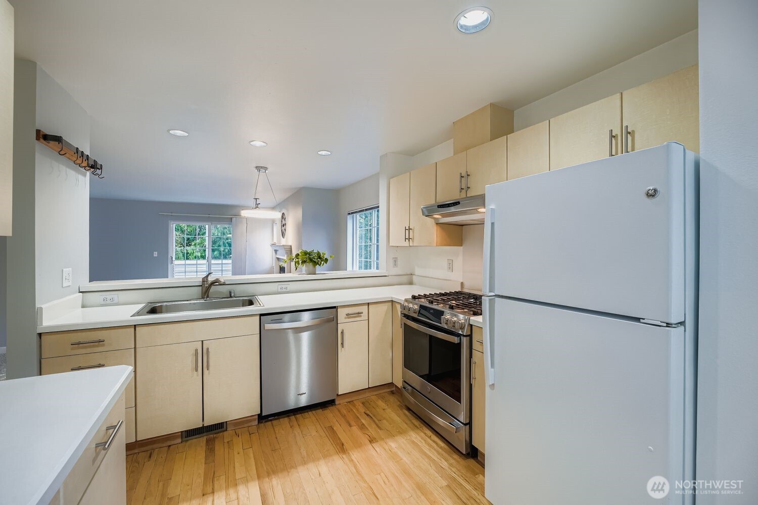 601 12th Avenue Northwest, Unit C1 Issaquah, WA 98027 - Photo 11 of 28 a kitchen with a sink a refrigerator and white cabinets