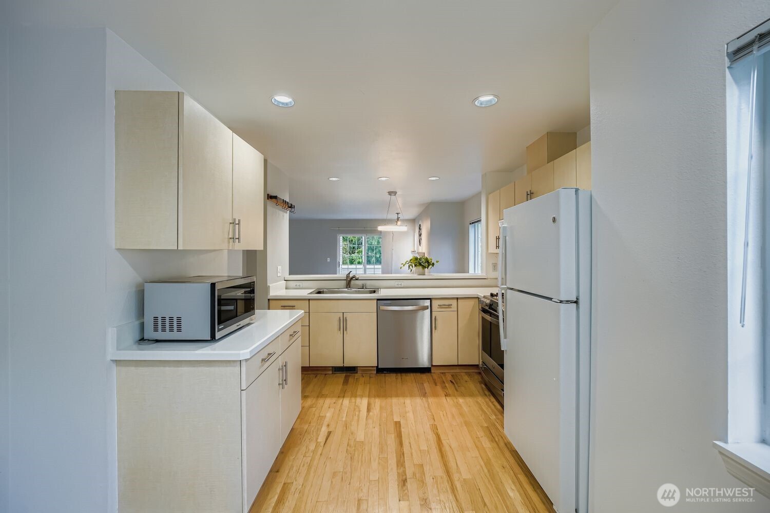 601 12th Avenue Northwest, Unit C1 Issaquah, WA 98027 - Photo 12 of 28 a kitchen with a refrigerator a sink and dishwasher a oven with white cabinets