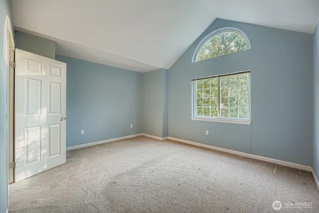 an empty room with windows and closet