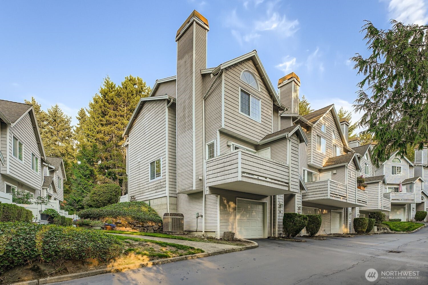 601 12th Avenue Northwest, Unit C1 Issaquah, WA 98027 - Photo 2 of 28 a front view of a house with a garden
