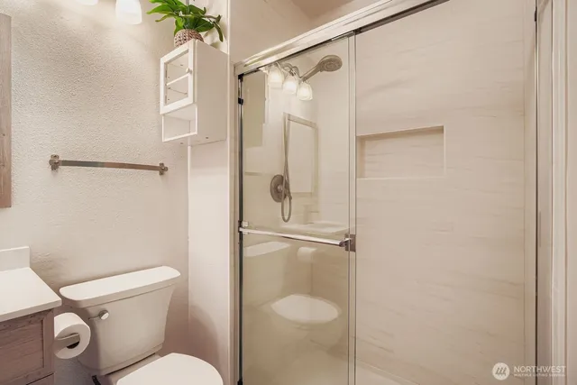 a bathroom with a toilet and a shower