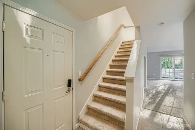 a view of entryway with wooden floor and stairs