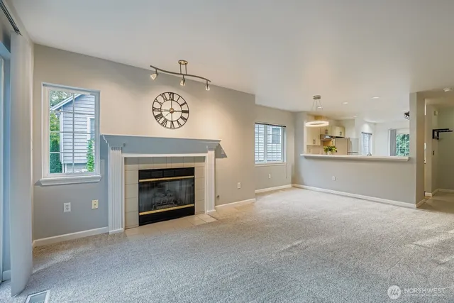a view of a livingroom with a fireplace and window