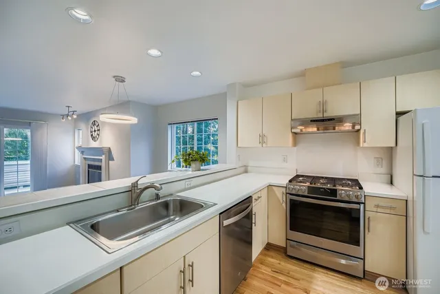 a kitchen with a sink stove and microwave