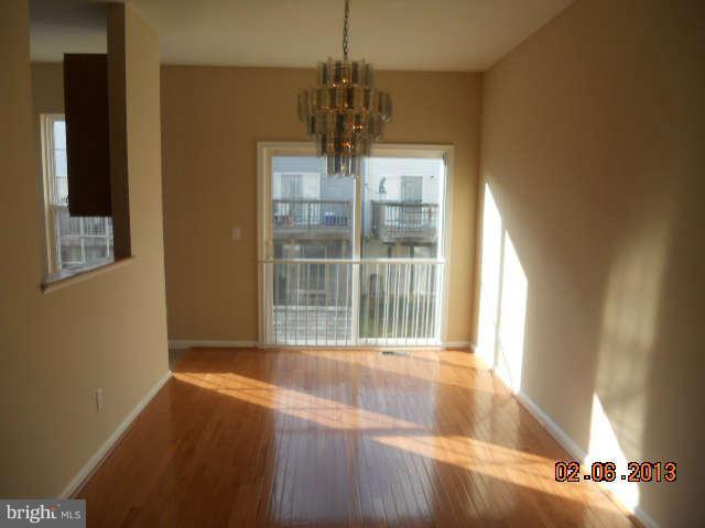 636 Luthardt Road Baltimore, MD 21220 - Photo 3 of 11 a view of empty room with wooden floor and fan