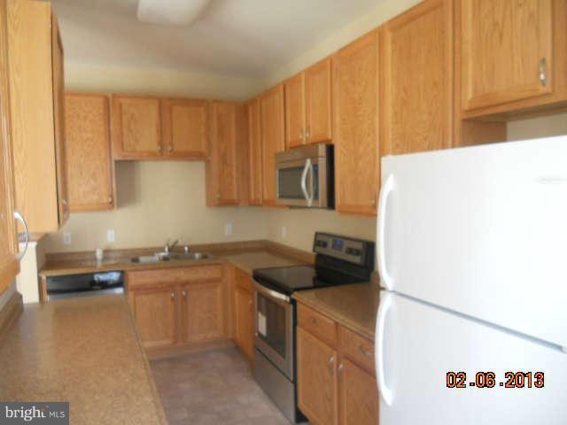 636 Luthardt Road Baltimore, MD 21220 - Photo 4 of 11 a kitchen with a sink a stove and cabinets