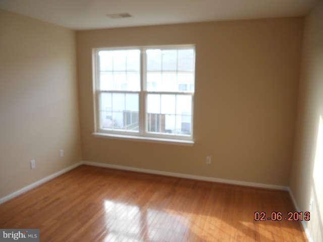 636 Luthardt Road Baltimore, MD 21220 - Photo 8 of 11 a view of an empty room with wooden floor and a window