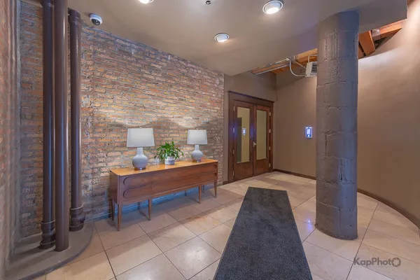a view of hallway with a couch and a potted plant
