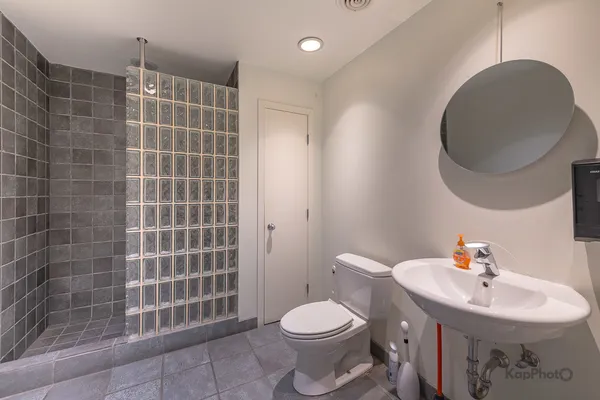 a bathroom with a sink toilet and a mirror