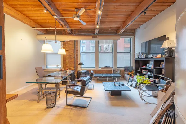 a living room with furniture and next to a window