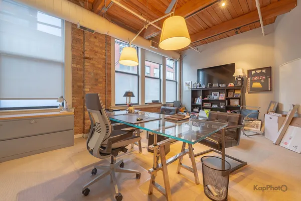 a work room with furniture and a lamp