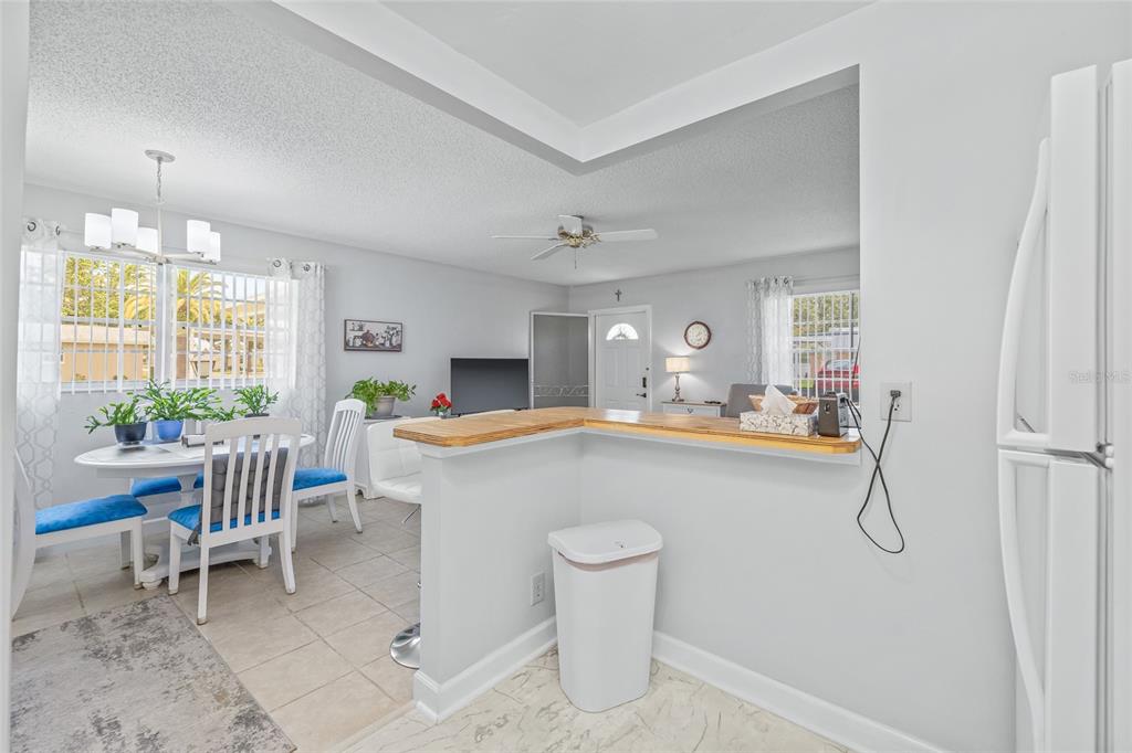 11923 Boynton Lane, Unit B New Port Richey, FL 34654 - Photo 15 of 34 a room with table chairs and entryway