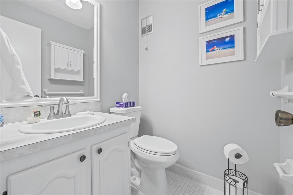 11923 Boynton Lane, Unit B New Port Richey, FL 34654 - Photo 16 of 34 a bathroom with a toilet sink and mirror