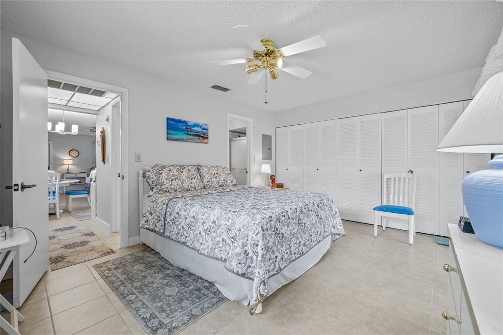 11923 Boynton Lane, Unit B New Port Richey, FL 34654 - Photo 18 of 34 a bedroom with a bed and a chandelier