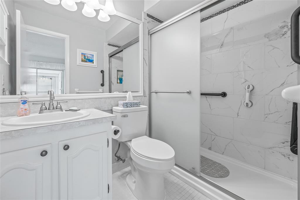 11923 Boynton Lane, Unit B New Port Richey, FL 34654 - Photo 20 of 34 a bathroom with a sink toilet and shower