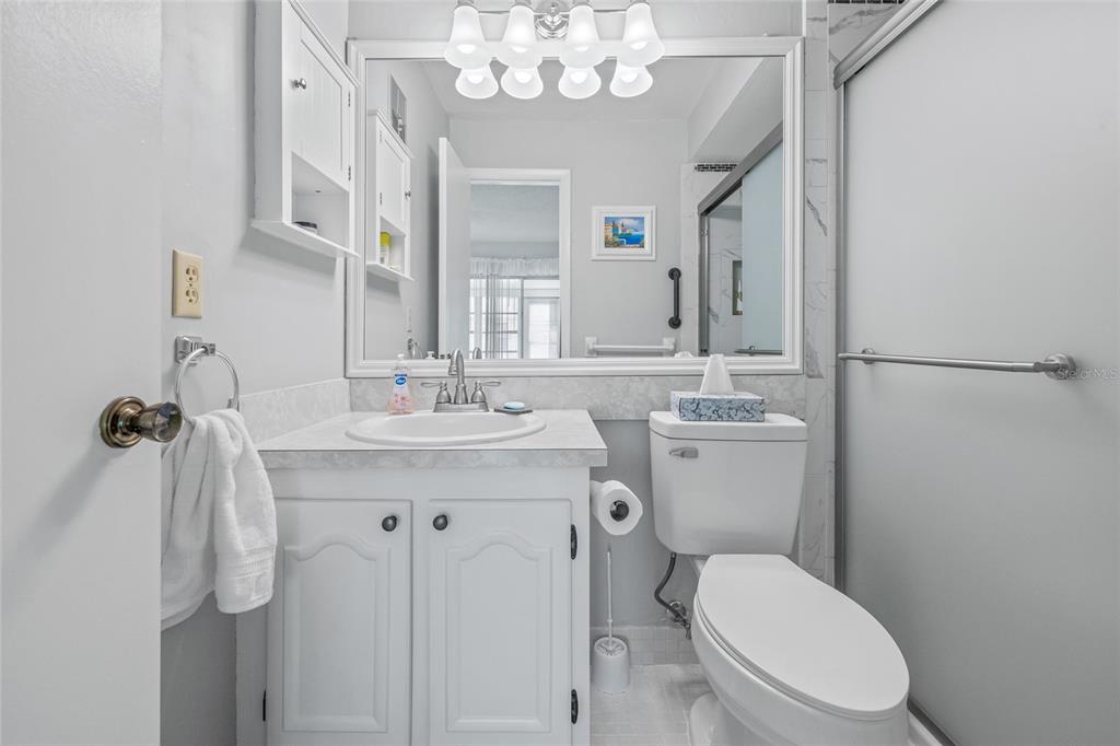 11923 Boynton Lane, Unit B New Port Richey, FL 34654 - Photo 21 of 34 a bathroom with a toilet a sink and mirror