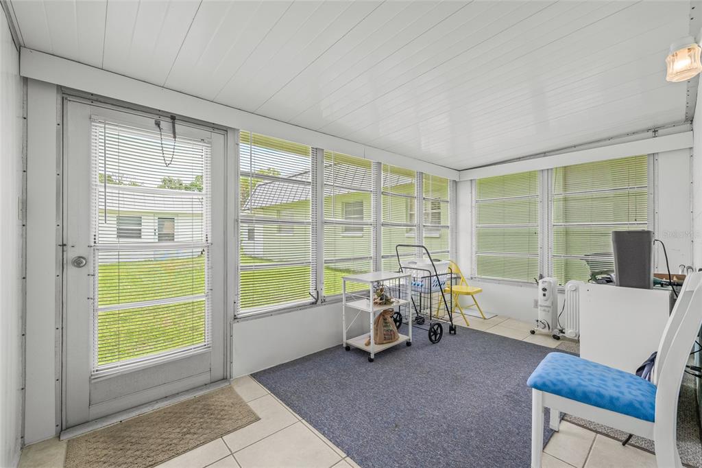 11923 Boynton Lane, Unit B New Port Richey, FL 34654 - Photo 22 of 34 a view of a livingroom with lounge chair and a large window