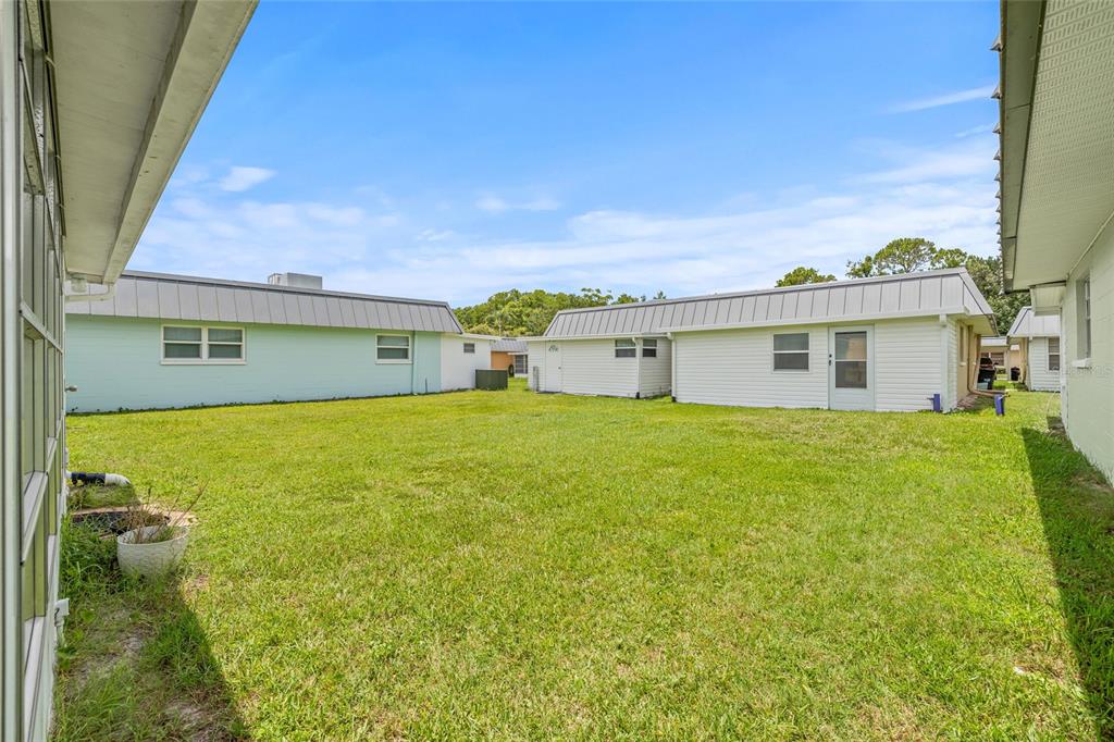 11923 Boynton Lane, Unit B New Port Richey, FL 34654 - Photo 25 of 34 a front view of a house with a garden