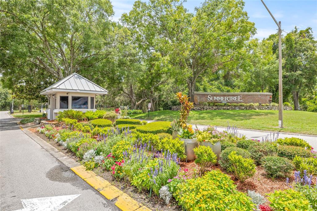 11923 Boynton Lane, Unit B New Port Richey, FL 34654 - Photo 34 of 34 a front view of house with a garden and swimming pool