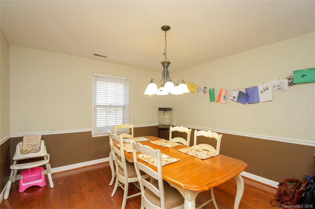 10212 Sardis Oaks Road Charlotte, NC 28270 - Photo 12 of 24 a view of a dining room with furniture and a chandelier
