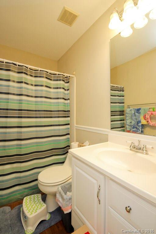 10212 Sardis Oaks Road Charlotte, NC 28270 - Photo 23 of 24 a bathroom with a sink a toilet and shower curtain