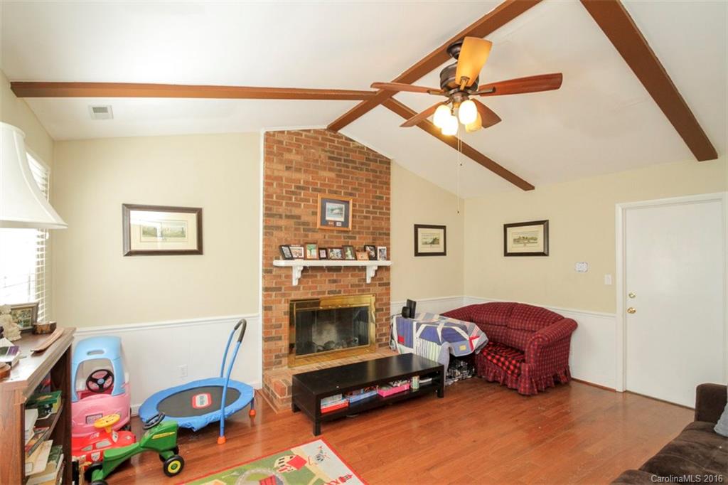 10212 Sardis Oaks Road Charlotte, NC 28270 - Photo 4 of 24 a living room with furniture and a fireplace