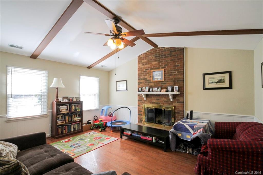 10212 Sardis Oaks Road Charlotte, NC 28270 - Photo 6 of 24 a living room with furniture a fireplace and a large window