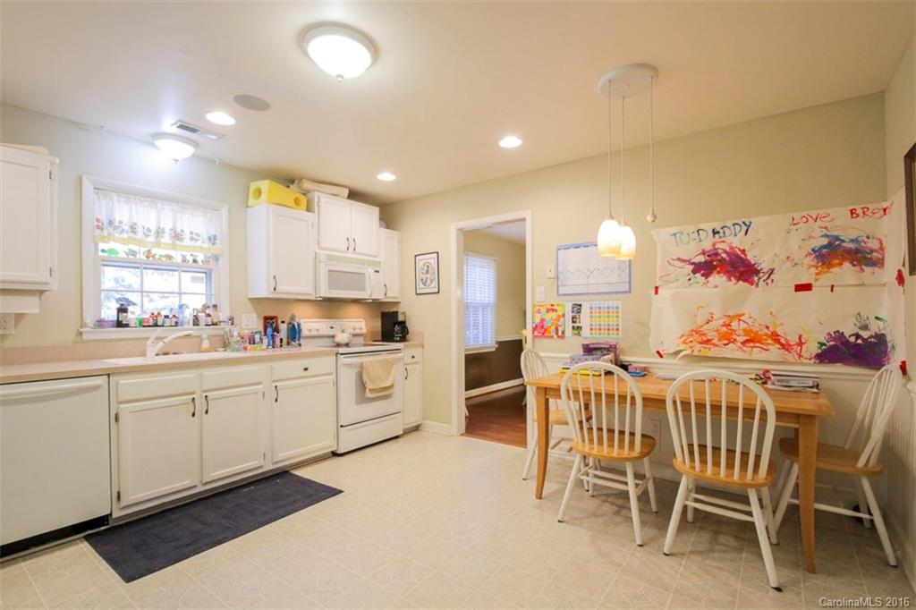 10212 Sardis Oaks Road Charlotte, NC 28270 - Photo 8 of 24 a kitchen with kitchen island cabinets and chairs in it