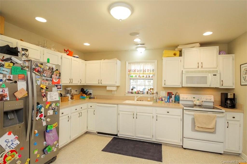 10212 Sardis Oaks Road Charlotte, NC 28270 - Photo 10 of 24 a kitchen with cabinets a sink and white appliances