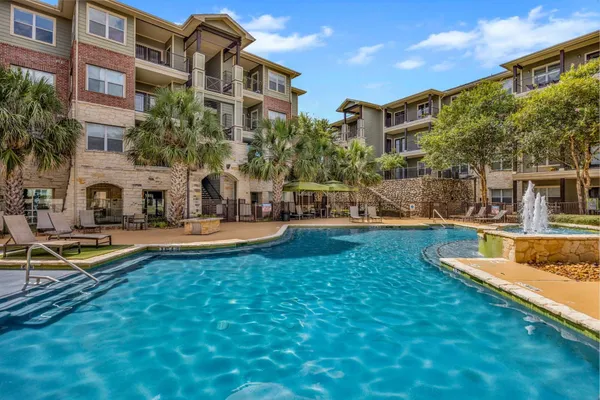 a view of a house with swimming pool and sitting area