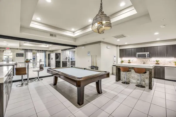 a room with gym equipment and view of a chandelier