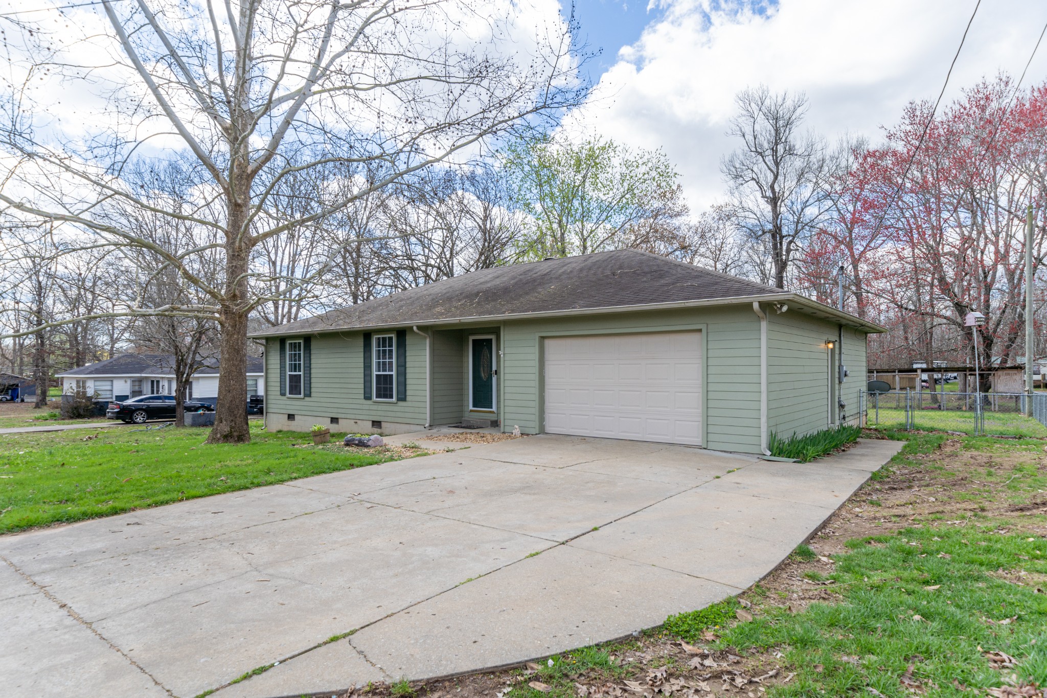 16 Town Road Fayetteville, TN 37334 - Photo 2 of 19 a front view of a house with a garden and trees