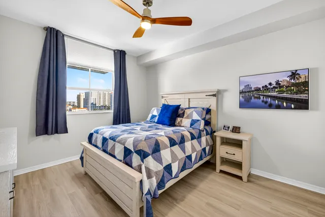 a bed sitting in a bedroom next to a window