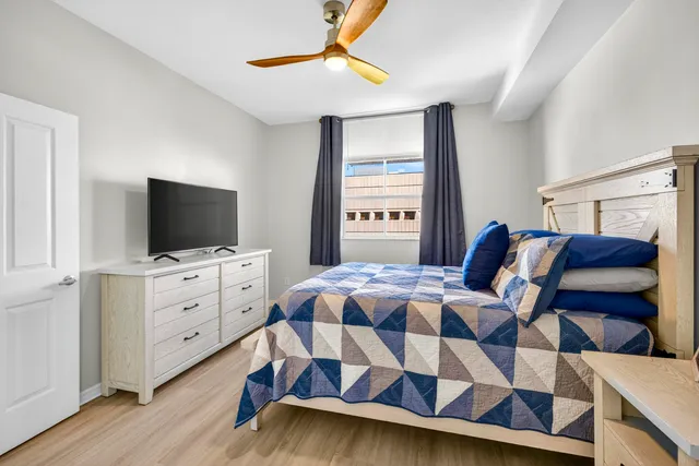 a bedroom with a bed and a flat screen tv