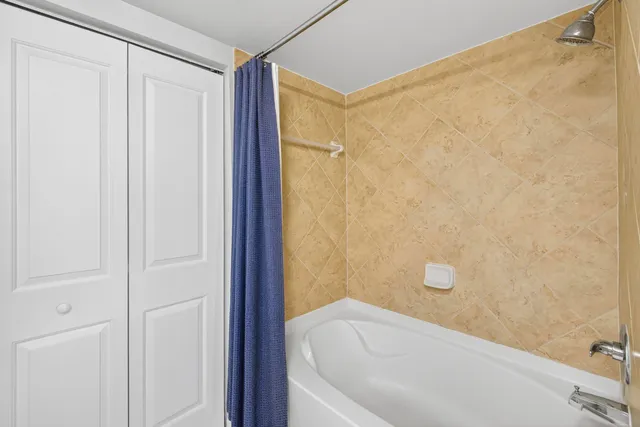 a bathroom with a bathtub and shower