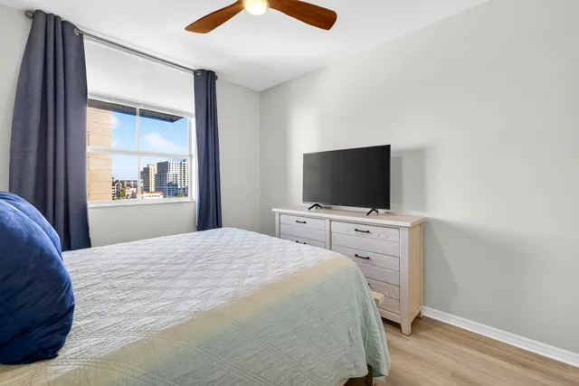 a bedroom with a bed and a flat screen tv