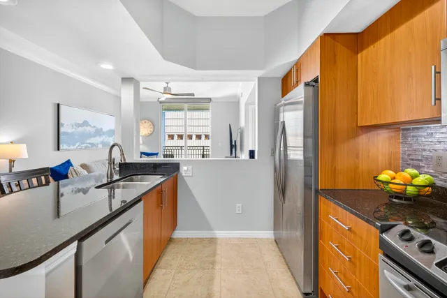 a kitchen with stainless steel appliances granite countertop a sink stove and refrigerator