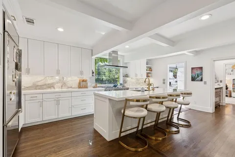 a kitchen with sink cabinets and dining table chair