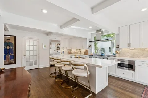 a kitchen with a sink a counter top space and appliances