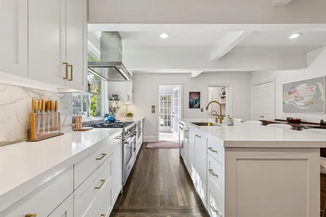 a large white kitchen with cabinets