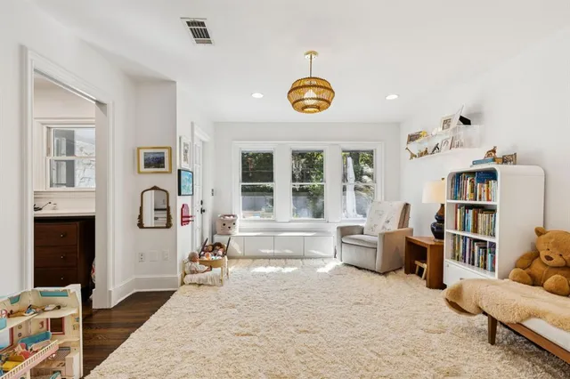 a living room with furniture and a book shelf