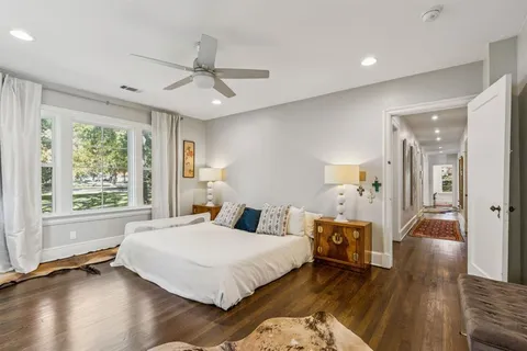 a bedroom with a bed and wooden floor