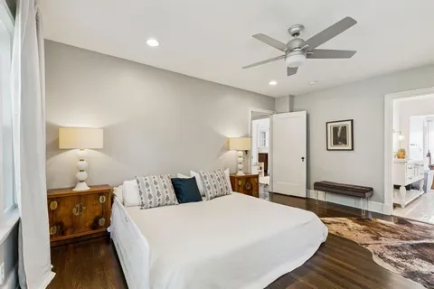 a bedroom with a bed and a chandelier