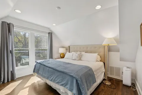 a bedroom with a large bed and a large window